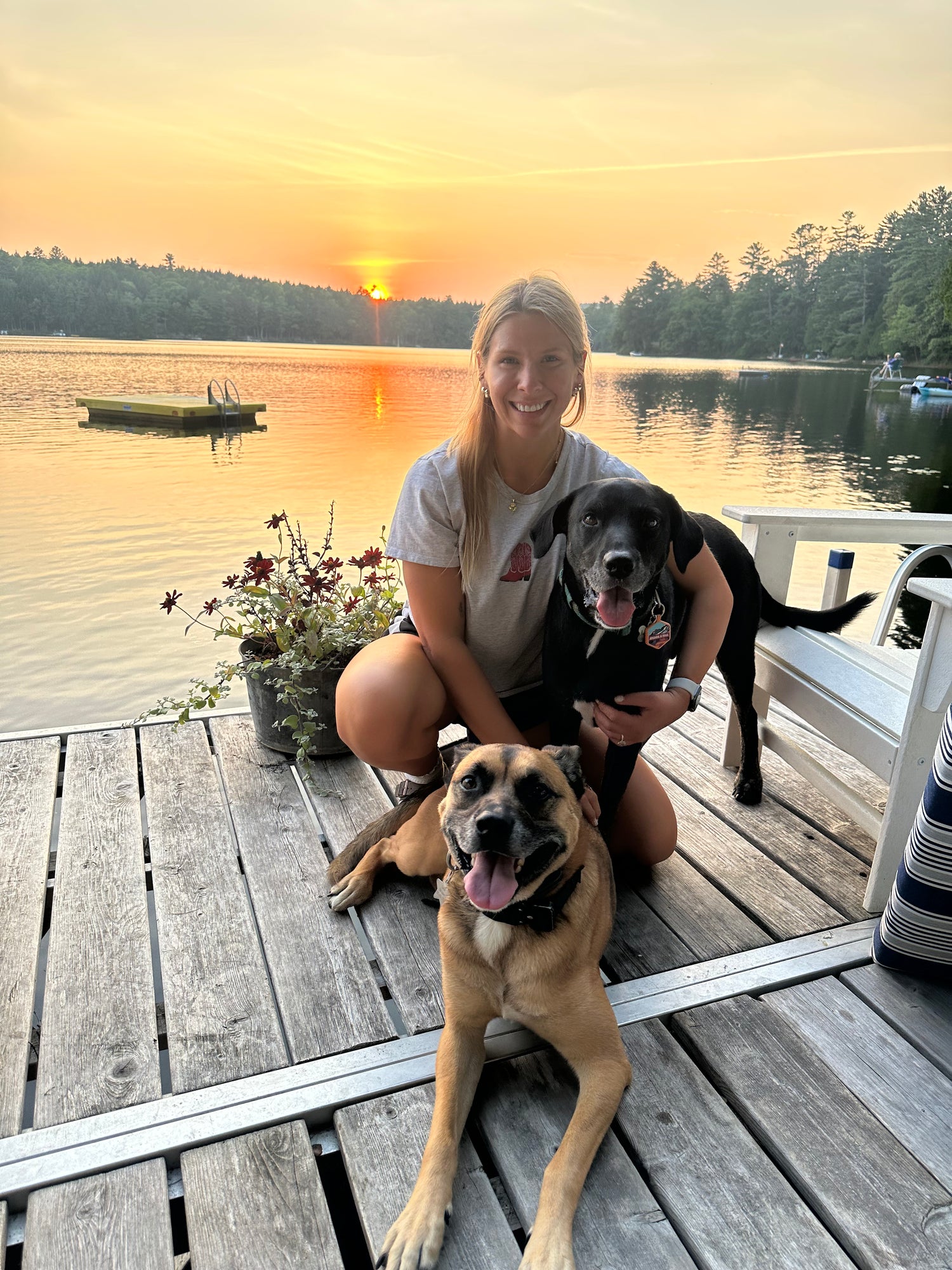 Girl on dock with two dogs in Maine